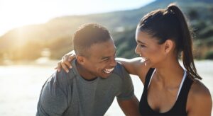 A Man and a woman laughing together outdoors