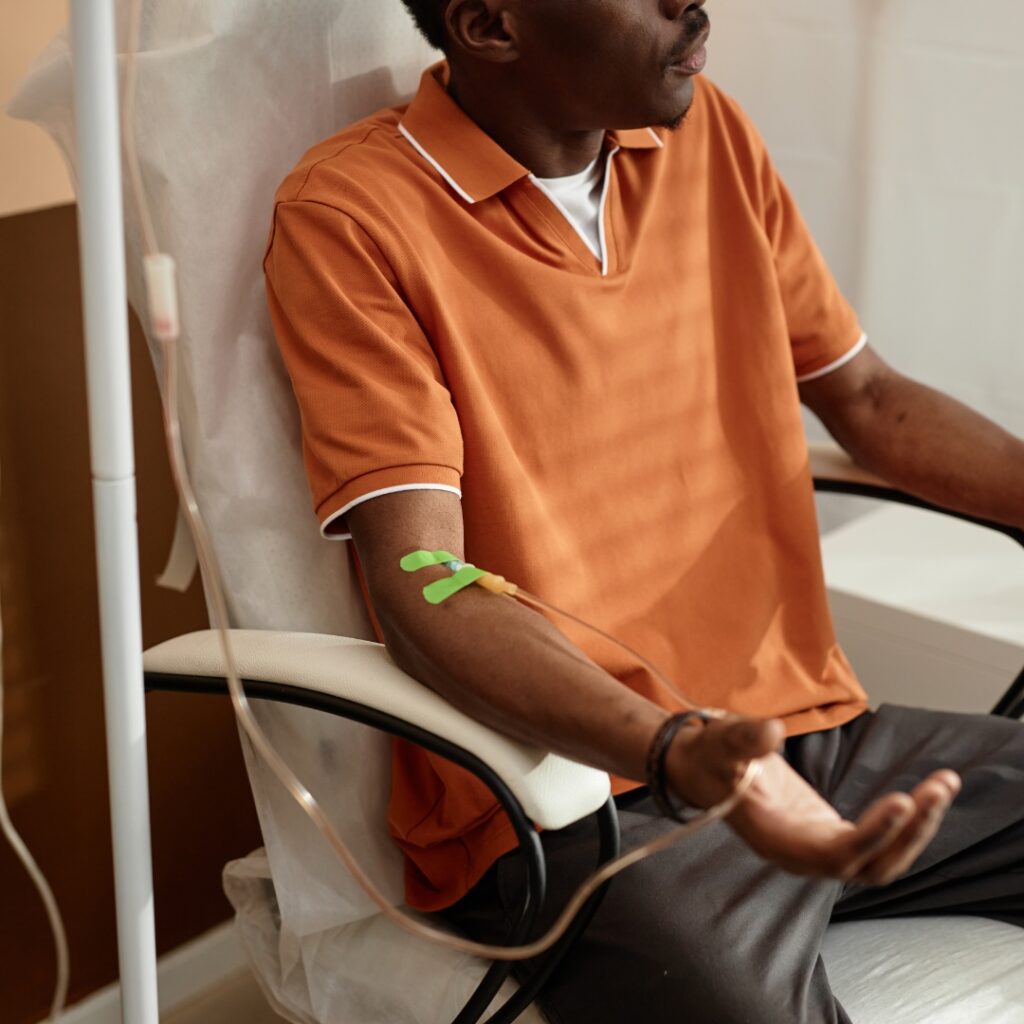 Man receiving an IV infusion in his arm