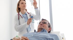 doctor adjusting a man' IV